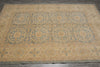 Load image into Gallery viewer, A large rectangular area rug with an ornate traditional pattern in muted blue and beige tones, laid flat on a dark gray tiled floor.