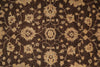 Load image into Gallery viewer, A close-up of a dark brown rug with a beige floral and vine pattern.
