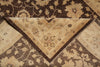 Load image into Gallery viewer, A close-up of a traditional patterned rug showing its corner fold, revealing a cream and brown floral design with a dark brown border.