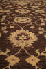 Load image into Gallery viewer, A close-up of a traditional patterned rug with a dark brown background and beige floral motifs.