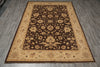 Load image into Gallery viewer, A rectangular area rug with an ornate floral pattern, featuring a dark brown center, a beige inner border, and a darker brown outer border, shown laid out on gray wood-look floor tiles.