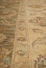 Load image into Gallery viewer, Close-up of a traditional patterned area rug with a central border and floral motifs in beige, brown, muted green, and soft red tones.