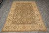 Load image into Gallery viewer, A rectangular area rug with a traditional floral pattern in beige, brown, and muted red tones, laid out on a gray wood-look floor.