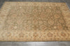 Load image into Gallery viewer, A large rectangular area rug with an ornate traditional floral and medallion pattern, shown laid out on a gray tiled floor.