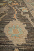 Load image into Gallery viewer, A close-up of a textured area rug featuring a traditional floral pattern in muted tones of beige, gray, light blue, and soft orange.
