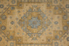 Load image into Gallery viewer, A close-up of a traditional oriental-style rug featuring a central medallion and geometric border patterns in beige, tan, muted blue, and gray.