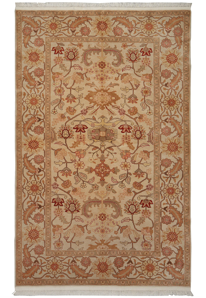 A traditional oriental area rug with an intricate floral and vine pattern, featuring a warm beige background with rust red, terracotta, and brown details, finished with white fringe on the top and bottom.