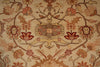 Load image into Gallery viewer, A close-up of a traditional floral patterned rug with a central medallion and scrolling vine motifs in beige, rust red, and brown tones.