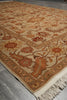 Load image into Gallery viewer, A traditional oriental-style area rug with a beige background and intricate floral motifs in rust orange, brown, and cream, shown laid out on a gray tiled floor.