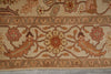 Load image into Gallery viewer, A close-up of a traditional patterned rug featuring a central floral motif, stylized birds, and geometric borders in beige, brown, and muted red tones.