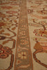 Load image into Gallery viewer, Close-up of a traditional patterned rug with a central floral border in beige, brown, and muted orange tones.