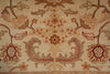 Load image into Gallery viewer, Close-up of a traditional patterned rug with a central floral medallion and scrolling vine motifs in beige, rust red, and brown tones.