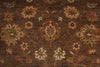 Load image into Gallery viewer, A close-up of a traditional patterned rug with a dark brown background and ornate floral motifs in beige, muted green, and rust orange.