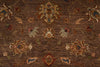 Load image into Gallery viewer, A close-up of a traditional patterned area rug with a brown base and ornate floral motifs in beige, rust red, blue, and muted green.