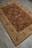 Load image into Gallery viewer, A rectangular area rug with an ornate floral pattern, featuring a dark brown central field and a light sage green border, laid out on a gray wood-look floor.