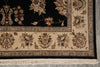 Load image into Gallery viewer, Close-up of a traditional oriental rug showing a black field with floral motifs, a beige border with ornate medallions and floral patterns, and cream fringe along the bottom edge.