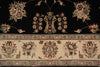 Load image into Gallery viewer, Close-up of an ornate floral rug pattern with a black upper field, a beige decorative border, and multicolored motifs including flowers, leaves, and central medallions.