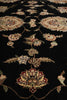 Load image into Gallery viewer, Close-up of a traditional oriental rug with a black background and ornate floral motifs in beige, muted green, and burgundy.