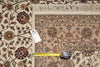 Load image into Gallery viewer, A close-up of a patterned area rug with a cream base and floral motifs in beige, brown, and muted red tones. A yellow tape measure lies across the rug, and a white product tag is attached near the left side.