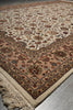 Load image into Gallery viewer, A traditional oriental-style area rug with an intricate floral pattern, featuring a beige and tan field, a peach-colored inner border, and cream fringe on the visible edge.