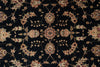 Load image into Gallery viewer, A close-up of an ornate floral patterned fabric or rug with a black background and cream, beige, and muted pink motifs.