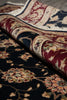 Load image into Gallery viewer, A close-up of a folded traditional area rug showing its detailed floral and vine pattern in deep navy blue, burgundy red, beige, and cream tones.