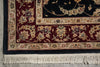 Load image into Gallery viewer, Close-up of a traditional patterned rug corner showing a dark navy blue field, deep burgundy border, cream floral motifs, and off-white fringe.