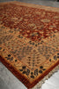 Load image into Gallery viewer, A traditional oriental area rug with a warm rust-red field, beige border, and dark brown floral motifs, shown laid out on a gray tiled floor.