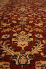Load image into Gallery viewer, A close-up view of a traditional oriental rug with a deep red-brown field, beige floral medallions, and accents of navy blue and cream.