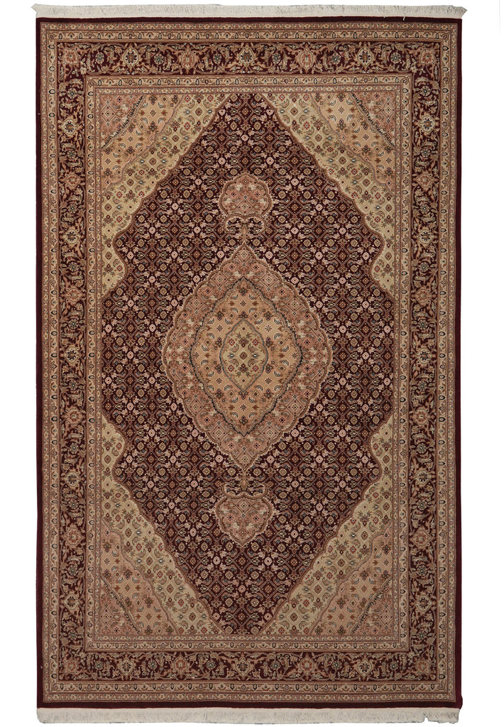 A traditional oriental area rug with a complex geometric and floral pattern in shades of dark brown, beige, and rust red, shown flat against a white background.