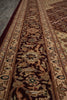Load image into Gallery viewer, A close-up view of a traditional oriental-style area rug with an intricate floral and geometric pattern in dark brown, beige, and muted blue tones.