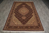 Load image into Gallery viewer, A traditional oriental area rug with an intricate floral pattern, featuring a dark brown central field, beige and gold accents, and a deep red border, laid out on a gray wood-plank floor.