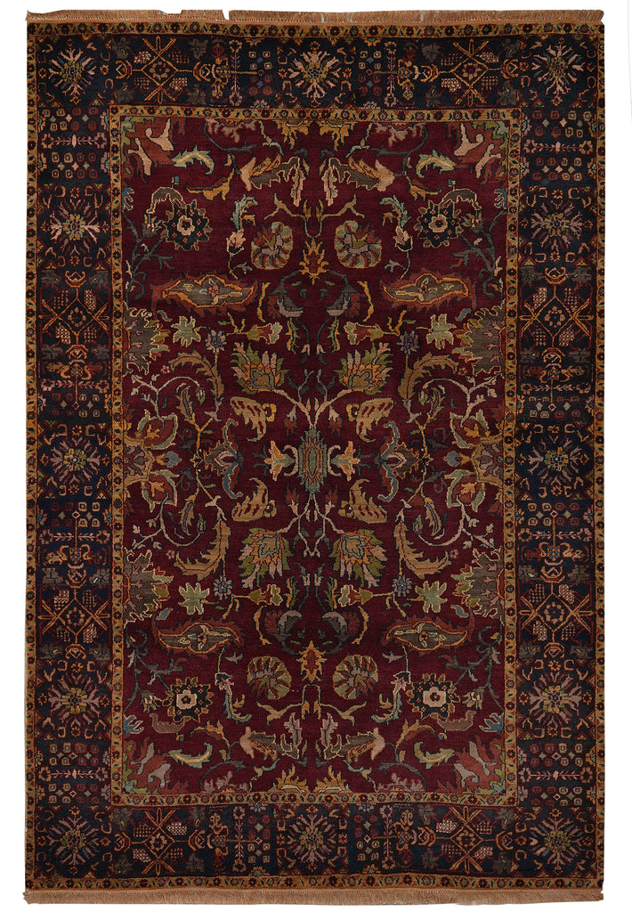 A traditional oriental-style area rug with a deep burgundy central field, dark navy blue borders, and intricate floral and bird motifs in beige, gold, and muted green.