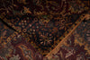 Load image into Gallery viewer, A close-up of an ornate patterned rug with a dark navy blue central field, deep burgundy borders, and tan fringe, showing detailed woven motifs.
