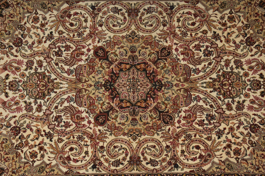An ornate traditional oriental-style rug with a detailed floral and scroll pattern in beige, brown, rust red, and muted green tones.