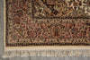 Load image into Gallery viewer, A close-up of an ornate traditional rug corner showing detailed floral and scroll motifs in beige, brown, and muted red tones, with cream fringe along the bottom edge.