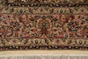 Load image into Gallery viewer, Close-up of an ornate patterned rug showing a central floral medallion and border motifs in beige, brown, red, black, and cream tones, with a cream fringe visible along the bottom edge.