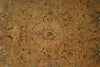 Load image into Gallery viewer, A close-up of an ornate vintage-style rug with a warm tan and ochre background, featuring a central floral medallion and intricate scrolling vine patterns in muted green, brown, and dusty pink.