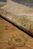 Load image into Gallery viewer, A close-up of a rolled area rug showing its detailed floral pattern in muted tones of beige, sage green, and terracotta.