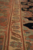 Load image into Gallery viewer, Close-up of an oriental-style area rug with a detailed central border in beige, rust red, and muted blue, alongside a dark navy patterned section.