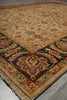 Load image into Gallery viewer, A traditional oriental-style area rug with a beige base and ornate floral motifs in red, green, and dark blue, shown laid out on a gray tiled floor.