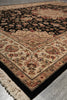 Load image into Gallery viewer, A traditional oriental-style area rug with an intricate floral pattern, featuring a black field, beige borders, and cream fringe, shown laid out on a gray floor.