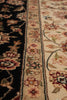 Load image into Gallery viewer, Close-up of an ornate area rug showing a beige field with floral motifs, a central patterned border, and a dark navy border with floral details.