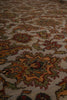 Load image into Gallery viewer, A close-up view of an ornate area rug with a traditional floral and medallion pattern in muted tones of beige, rust, olive green, and burgundy.