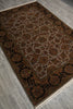 Load image into Gallery viewer, A traditional oriental-style area rug with an intricate floral pattern, shown laid out on a gray wood-look floor. The rug features a dark brown and black patterned border and a beige center field with warm rust and brown floral motifs.