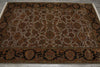 Load image into Gallery viewer, An oriental-style area rug with an intricate floral and medallion pattern, featuring a beige center field, dark brown and black borders, and rust-orange accents, laid out on a gray floor.