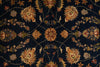 Load image into Gallery viewer, A close-up of a dark navy blue patterned rug with an ornate floral design in beige, rust, and muted green.