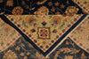 Load image into Gallery viewer, A close-up of a traditional oriental rug showing a V-shaped corner with a beige center, navy blue borders, and floral motifs in gold, rust, and green.