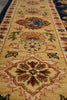 Load image into Gallery viewer, A close-up view of a traditional patterned area rug with a warm beige base, featuring large central medallions and floral motifs in red, blue, green, and orange.