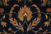 Load image into Gallery viewer, Close-up of a traditional patterned rug featuring a central floral motif in warm gold, orange, and beige tones on a dark navy blue background.